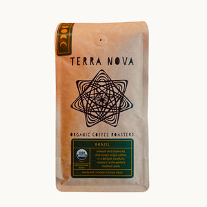 Terra Nova Organic Coffee is  proud to offer Rainforest Alliance Certified organic coffee direct from Brazil. We carefully roast the arabica beans to the perfect medium-dark, bringing forward balanced notes of hazelnut, nougat, and dried fruit. The family owned and operated farm we source our beans from is focused on biodiversity and sustainable land management, making this coffee even easier to enjoy!